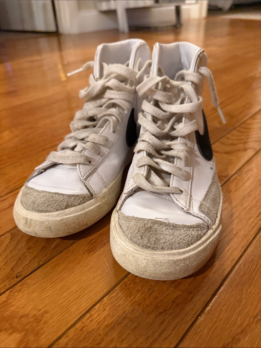 Nike White High-Top Sneakers with Black Swoosh